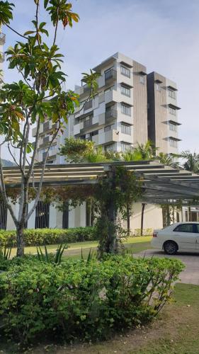 a white car parked in front of a building at TESS - By The Sea, Batu Ferringhi Penang in Batu Ferringhi