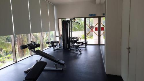 a gym with treadmills and machines in a room at TESS - By The Sea, Batu Ferringhi Penang in Batu Ferringhi