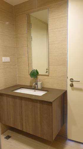 a bathroom with a sink and a mirror at TESS - By The Sea, Batu Ferringhi Penang in Batu Ferringhi