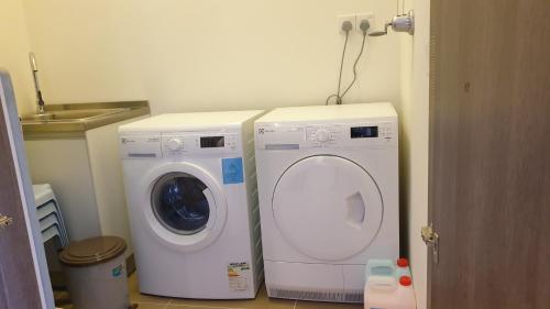 two washing machines sitting next to each other in a kitchen at TESS - By The Sea, Batu Ferringhi Penang in Batu Ferringhi