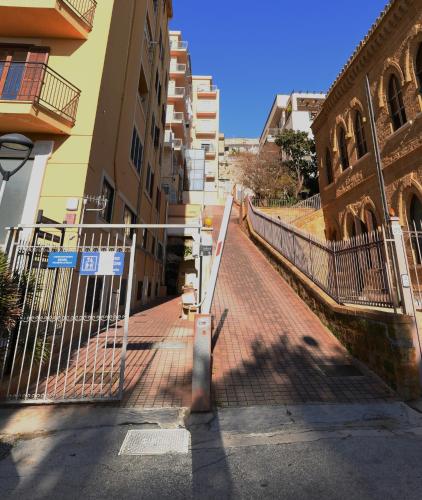 a gate in the middle of a street with buildings at Hedoné Design Experience B&B in Agrigento