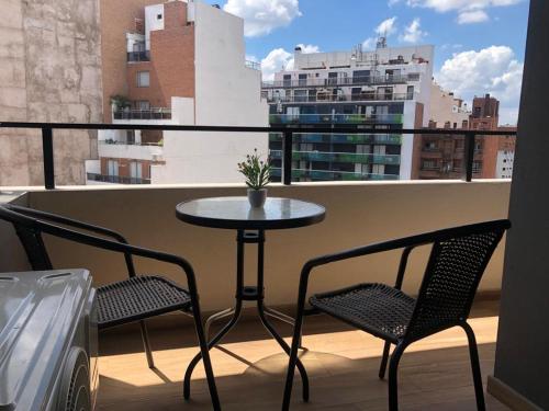 a small table and two chairs on a balcony at Departamento Boutique II en Nueva Cordoba in Córdoba