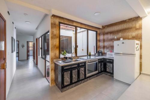 a kitchen with a refrigerator and a sink at Mexico Historic Center Modern Apartment in Mexico City