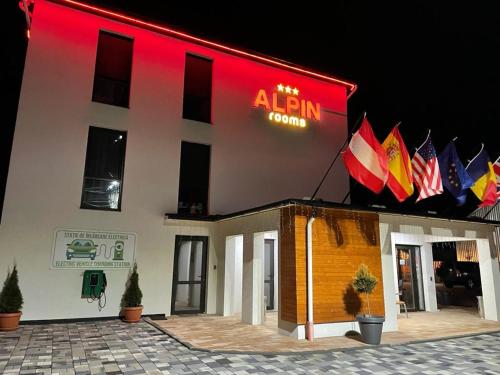 a building with a sign on the side of it at ALPIN rooms in Topliţa