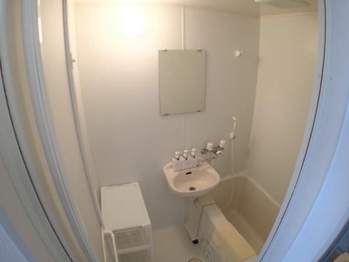 a small bathroom with a sink and a toilet at Lagoon Palace - Vacation STAY 95305v in Nogunukaniku