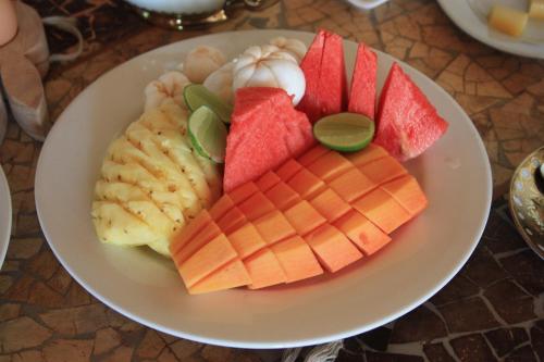 a plate of food with fruit on a table at Bali Marina Villa's in Amed