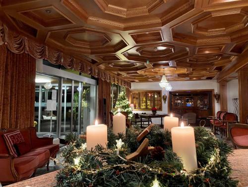 a lobby with a christmas tree and candles at Hotel Regina Terme in Leukerbad