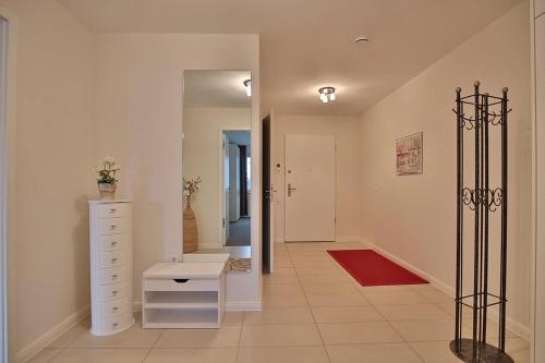 a bathroom with a white dresser and a mirror at Villa Mér Baltique Villa Mér Baltique Appartement 13 in Timmendorfer Strand