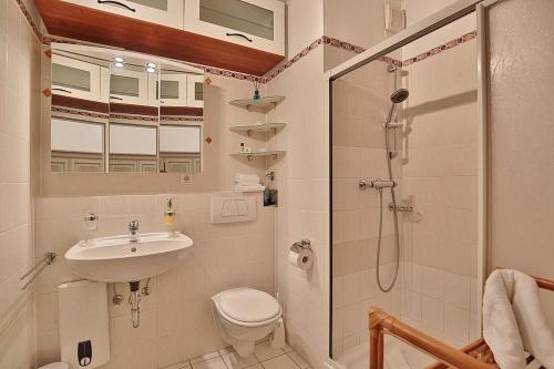 a bathroom with a sink and a toilet and a shower at Maison Baltique Tdf Strand Maison Baltique Appartement 5 in Timmendorfer Strand