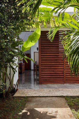 a garage with a wooden door in a house at Savane Paille in Deshaies