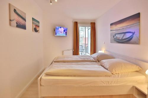Ένα ή περισσότερα κρεβάτια σε δωμάτιο στο Residenz Ostseestrand Appartement 5