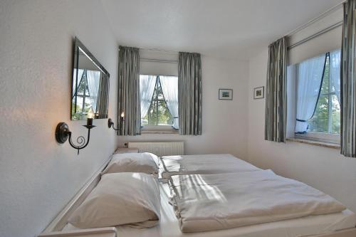 Säng eller sängar i ett rum på Ostseeblick Ostseeblick Appartement 6