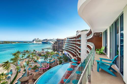
a balcony overlooking a beach with a view of the ocean at Margaritaville Beach Resort Nassau in Nassau
