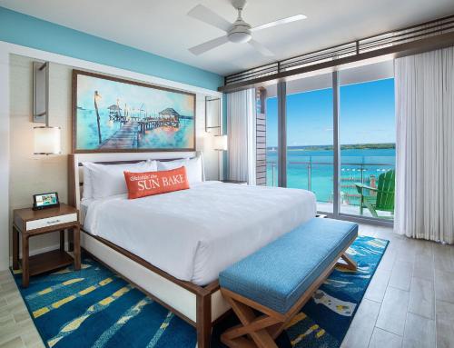 a bedroom with a large bed and a large window at Margaritaville Beach Resort Nassau in Nassau