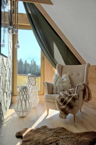 a living room with a couch and a large window at W Sercu Tatr in Rzepiska