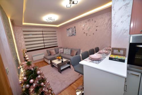 a living room with a christmas tree in a living room at Sunset Lux S3 Wellness & Spa Zlatibor in Zlatibor