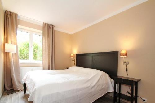 Postel nebo postele na pokoji v ubytování Wohnpark am Mühlenteich Wohnpark am Mühlenteich Appartement 07