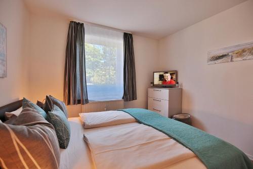 Postel nebo postele na pokoji v ubytování Gorch-Fock-Straße 34 Gorch-Fock-Str 34 Appartement 1