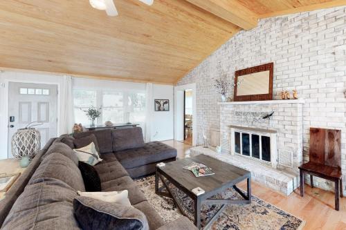 a living room with a couch and a fireplace at Dragonfly Cove in Glenora
