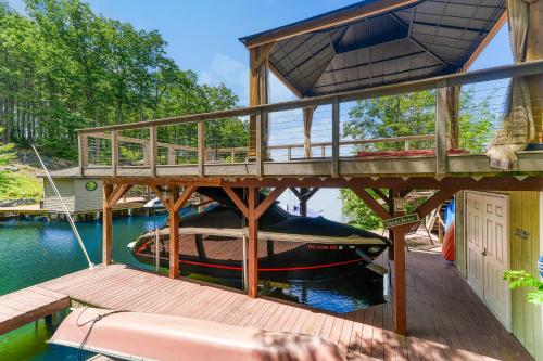 a house with a boat on the water at Dragonfly Cove in Glenora