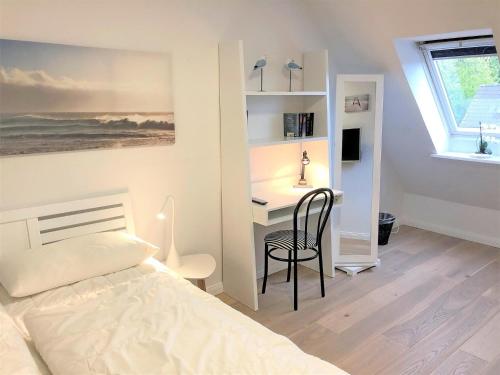 1 dormitorio con 1 cama y escritorio con silla en Maisonnette mit Charme Maisonette mit Charme, en Scharbeutz