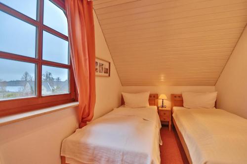 Ένα ή περισσότερα κρεβάτια σε δωμάτιο στο Ferienhaus Seeweg Ferienhaus Seeweg 4