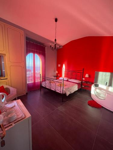a red bedroom with a bed and a bath tub at Villa Gaia - Luxury Villa, pool & wellness rooms in Bordighera