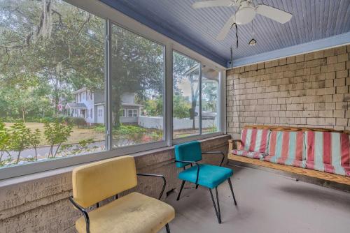 a room with two chairs and a bed and windows at Chic Ocala Home with Yard about 1 Mi to Dtwn Square in Ocala