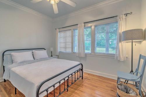 a bedroom with a bed and a chair and windows at Chic Ocala Home with Yard about 1 Mi to Dtwn Square in Ocala