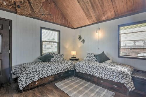 a bedroom with two beds and a window at Walk to Shore: Cottage w/ Deck in Surfside Beach! in Freeport
