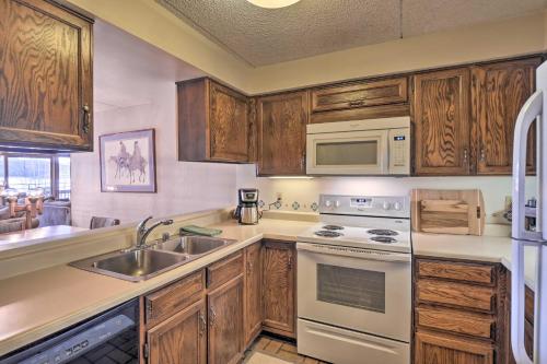 a kitchen with a sink and a stove top oven at Less Than 15 Mi to Breck Dillon Condo with Fireplace in Dillon