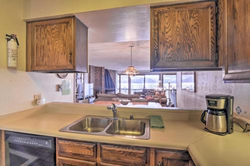 a kitchen with a sink and a living room at Less Than 15 Mi to Breck Dillon Condo with Fireplace in Dillon