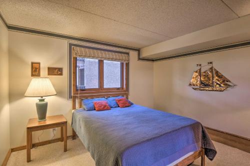 a bedroom with a bed and a lamp and a window at Less Than 15 Mi to Breck Dillon Condo with Fireplace in Dillon