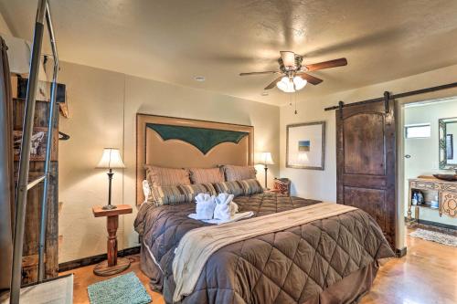 a bedroom with a large bed with a ceiling fan at Hike, Shop and Unwind Tucson Home with Shared Hot Tub in Tucson