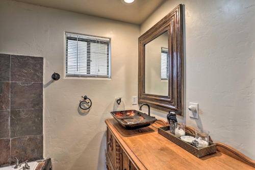 a bathroom with a sink and a mirror at Tucson Casita with Courtyard, Hot Tub and Fire Pits! in Tucson