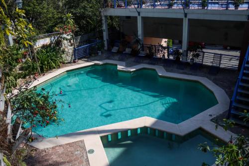 an overhead view of a swimming pool with blue water at Hotel El Mirador in Puerto Escondido