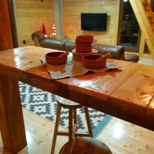 a wooden table with bowls on top of it at Lozanski ambar in Boljevac