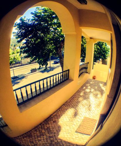 a view through a circular window of a building at Hospedaria Pielas in Sintra