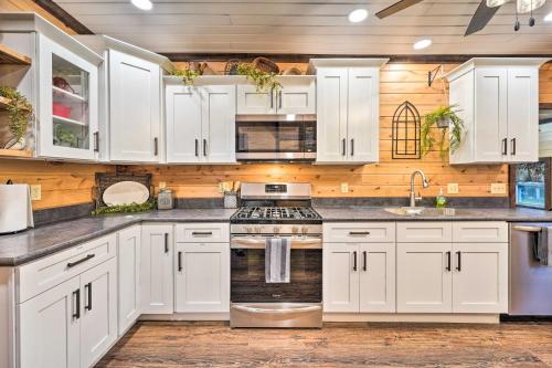 a kitchen with white cabinets and stainless steel appliances at The Olde Homestead with Mtn Views Near Coudersport in Coudersport