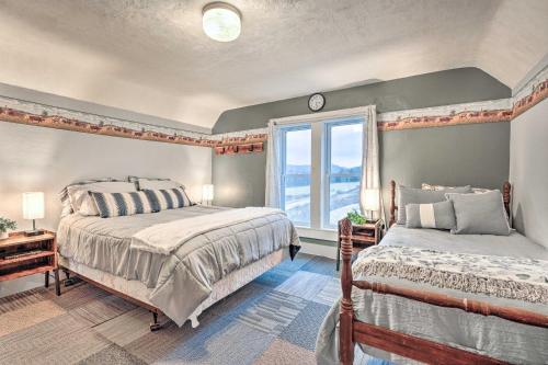 A bed or beds in a room at The Olde Homestead with Fire Pit and Mountain Views!