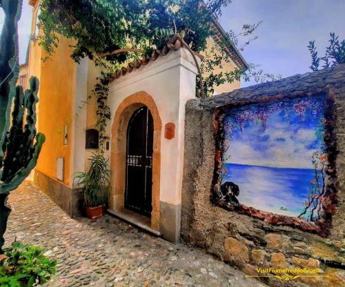 a building with a painting on the side of it at Residenza Matilde in Fiumefreddo Bruzio