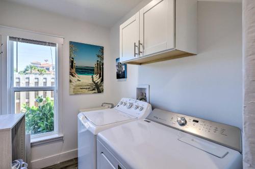 a white laundry room with a sink and a window at Chic Cocoa Beach Oasis with Pool - Steps to Shore! in Cocoa Beach