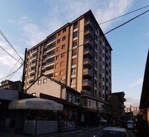 a tall building on the side of a street at Apartman DalMe in Novi Pazar