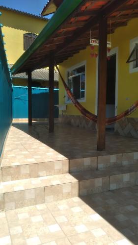 a patio with a hammock in front of a house at Alta Vista in Penedo