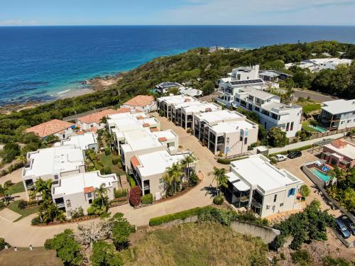 an aerial view of a resort with the ocean at The Point Coolum in Coolum Beach
