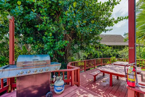 a patio with a grill and a picnic table on a deck at Kalanikai #218 in Kailua-Kona