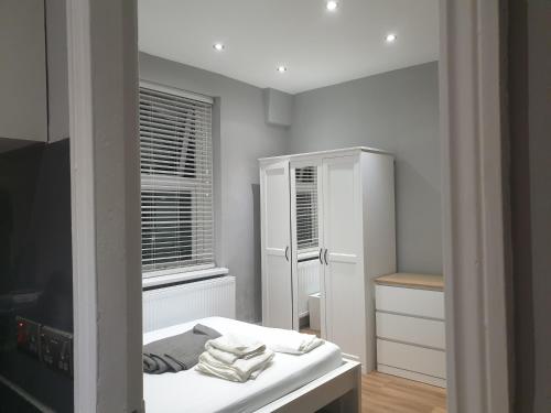 a white room with a bed and a mirror at Lovely 1 bedroom flat High Barnet 3 mins away in Barnet