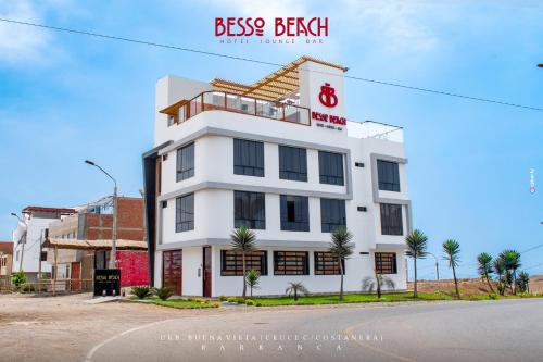 a white building on the side of a street at Besso Beach Hotel in Barranca