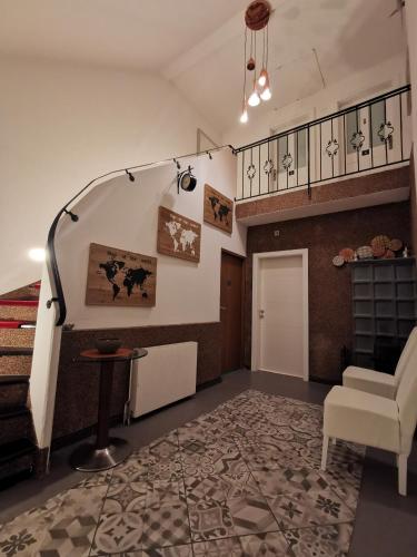 a room with a staircase with a chair and a table at Pension Föhrenhain in Gerasdorf bei Wien