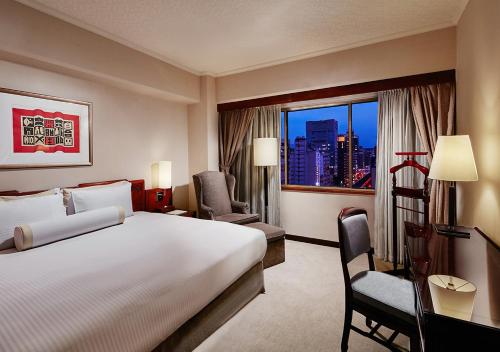 a hotel room with a large bed and a window at The Howard Plaza Hotel Taipei in Taipei